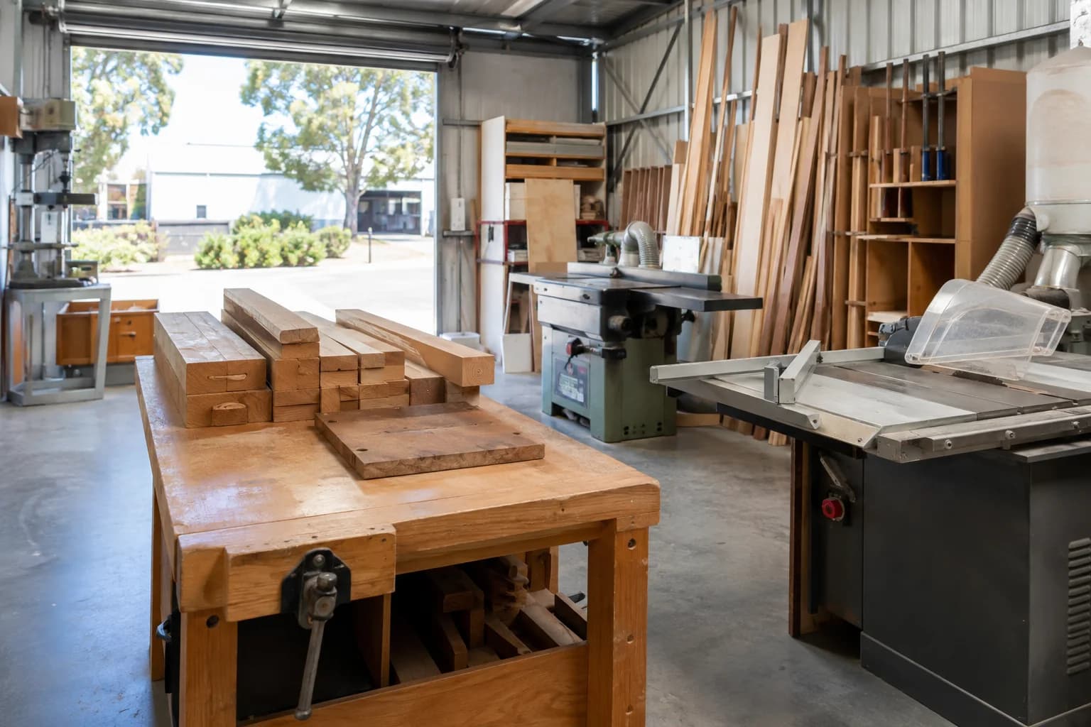 Timber and equipment inside a working small-business workshop